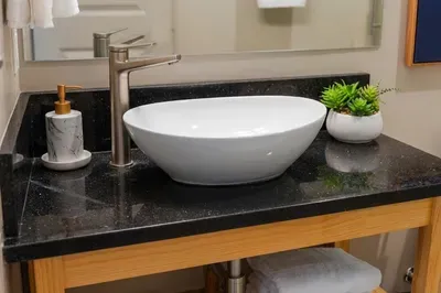 This bathroom keeps the guest suite feeling easy, with counter space where it counts and a shower close by when the day runs long.