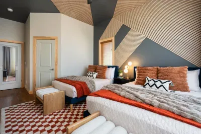 The room the cousins or kids claim first the moment they walk in. Two beds, layered throws, and the kind of cozy that turns a late arrival into the trip's easiest, quietest moment.