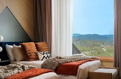Pull back the curtain and the mountains are right there waiting at the foot of the bed. A view this close to the pillow makes mornings the part of the day everyone shows up for.