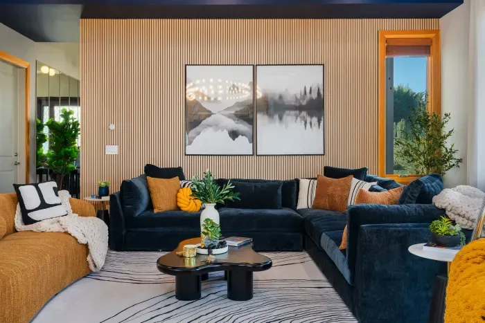 Designer living room with plush sectional, art wall, and cozy modern style