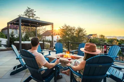 Fire pit lit, chairs pulled close, the ridgeline holding the last of the light. The late-evening gather everyone stays out for that turns into the trip's best memory.