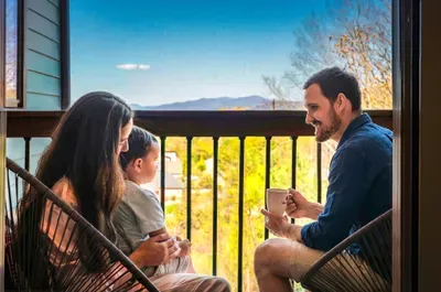 Coffee on a private balcony with long-range mountain views, where the unofficial morning gathering happens slow and easy before anyone in the house thinks about the day ahead.