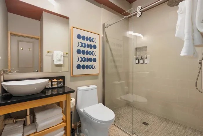 Rainfall overhead, hot water on tap, the kind of post-hike rinse that earns the rest of your evening. Plush towel and fresh soap ready when you're done.