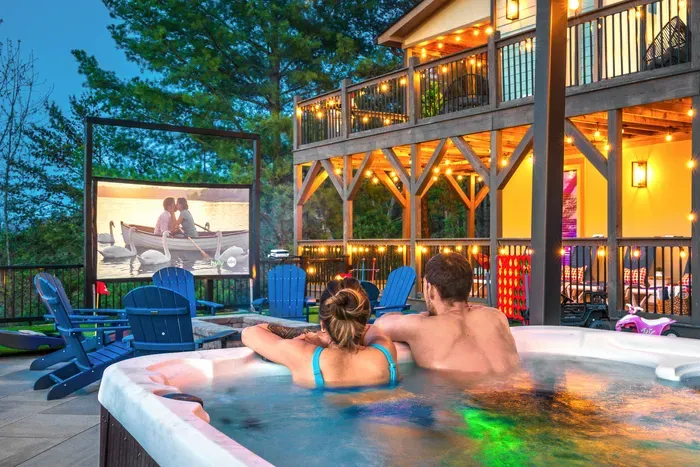 Movie up on the screen, soak going, lights strung along the railings, the house warm behind you. The kind of group night-in that only ever really happens up the mountain.