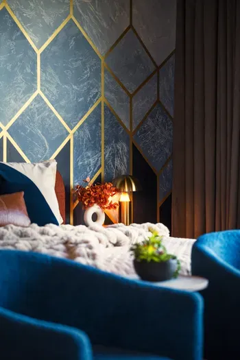 The corner of the primary suite where the night winds down. Soft lamplight, a chair pulled close, and the kind of conversation that only happens after the rest of the house has gone quiet.