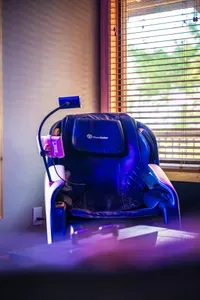 The massage chair tucked into the upstairs wellness corner, the kind of amenity you forget you booked until your legs hit it after a long Blue Ridge day on the trails.