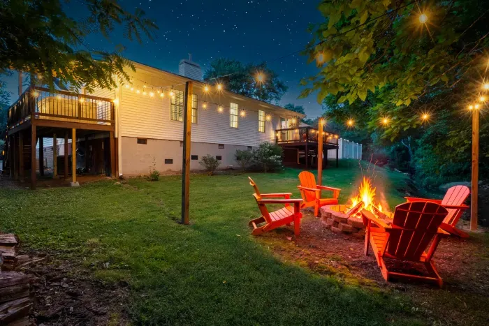 Cozy backyard fire pit with string lights and spacious lawn retreat