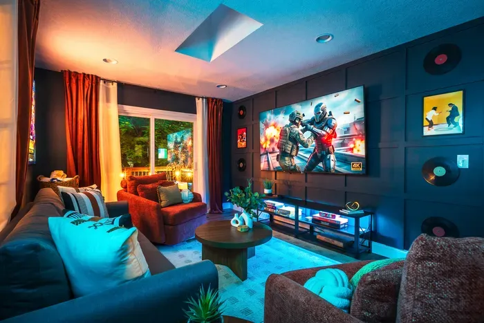 Cozy media lounge with big-screen TV, stylish decor, and plush seating