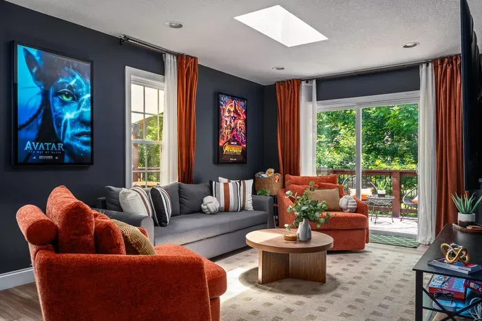 Modern lounge with bold decor, natural light, and private deck access