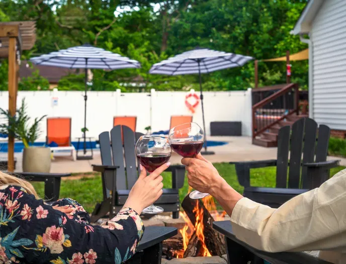 Cozy fire pit seating beside a private pool retreat