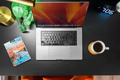 Stylish work-from-home setup with coffee and local Asheville guide