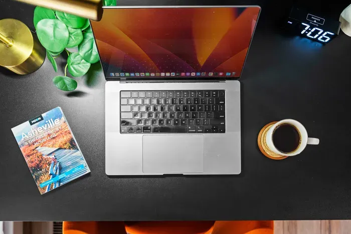 Stylish work-from-home setup with coffee and local Asheville guide