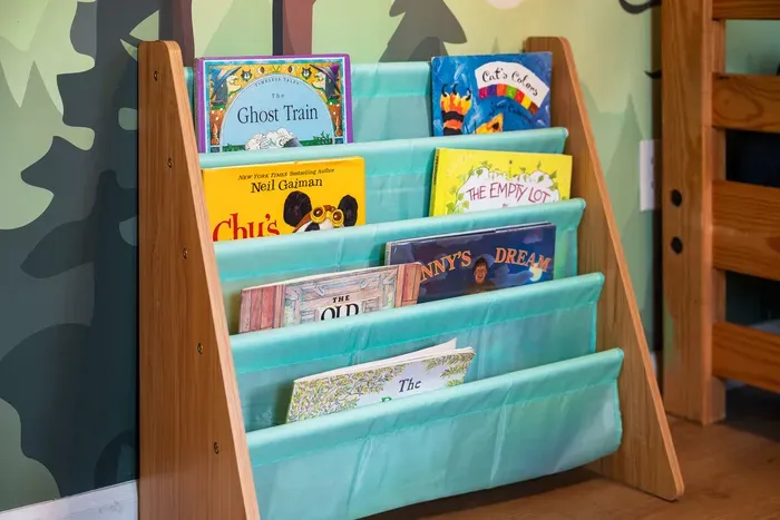Cozy kids’ reading nook with colorful books and playful woodland charm