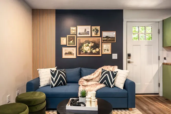 Cozy designer lounge with bold accent wall and stylish gallery art