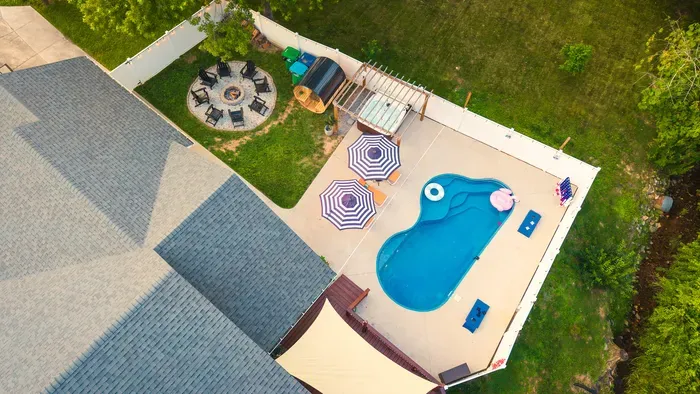 Private backyard oasis with pool, hot tub, umbrellas & fire pit
