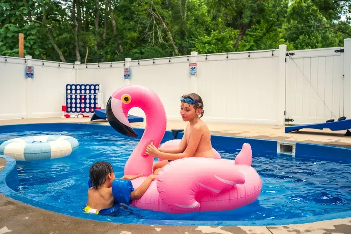 Private fenced pool with fun floats for the perfect family swim day