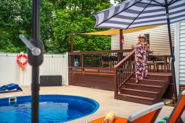 Private pool and shaded deck dining in a lush fenced backyard