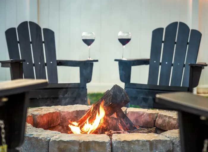 Cozy fire pit lounge with Adirondack chairs for relaxing evening nights