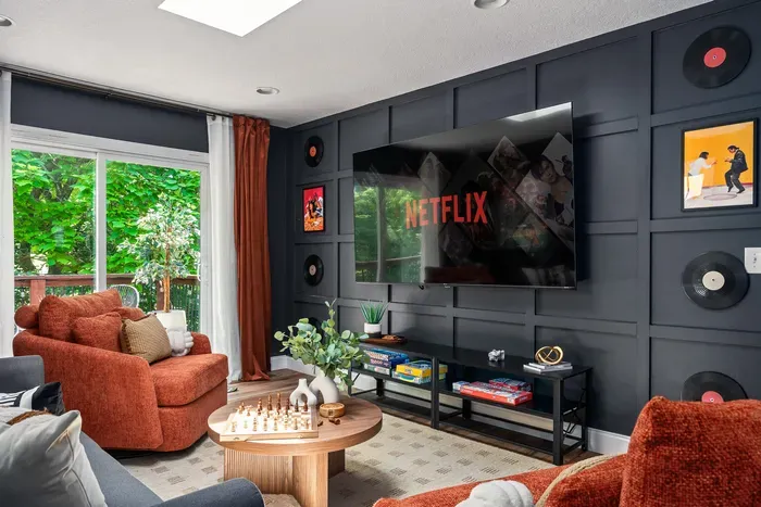 Cozy designer lounge with big-screen TV and lush garden views