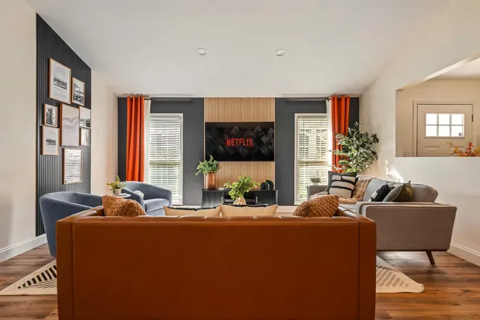 Stylish, sunlit lounge with cozy seating and TV for movie nights