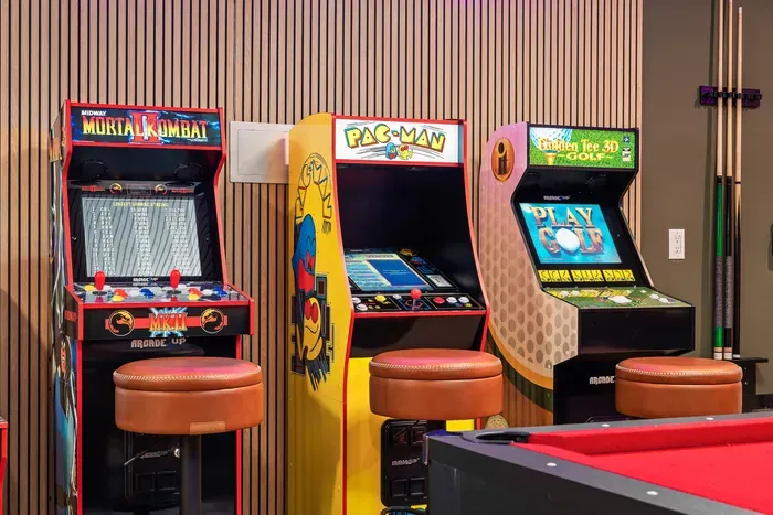 Retro game room with arcade classics, pool table, and stylish lounge vibes