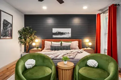 Cozy designer bedroom with accent wall and private sitting area