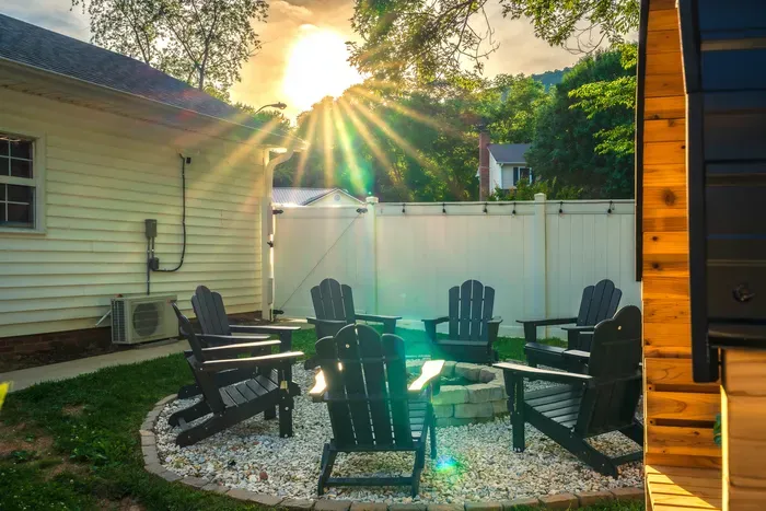 Private fire pit patio with Adirondack chairs and glowing sunset views