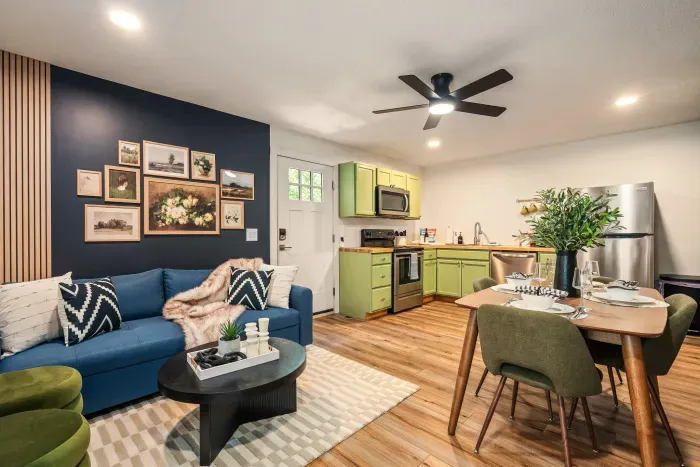 Stylish open living space with cozy seating, dining for 4, and chic kitchen