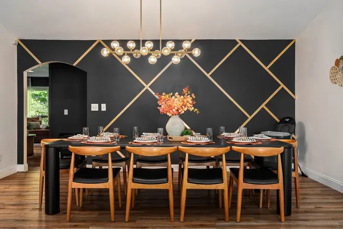 Modern dining room for 8 with bold accent wall and statement lighting