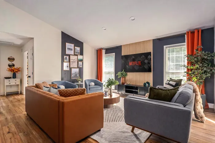 Modern, cozy living room with big TV and stylish seating