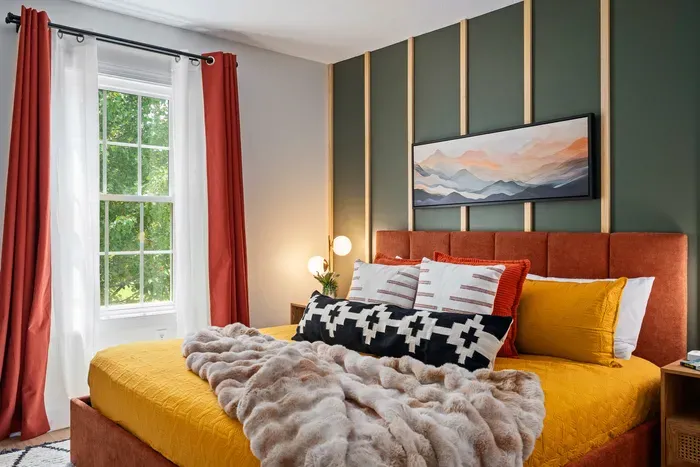 Stylish bedroom retreat with bold accents, cozy textures, and sunny window views
