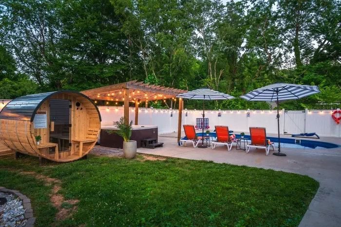 Private backyard oasis with pool, hot tub, sauna & string lights