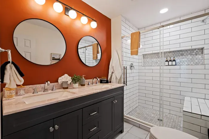 Modern spa-style bathroom with double vanity and oversized walk-in shower
