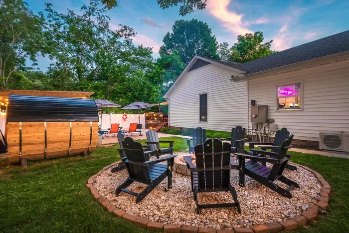 Cozy backyard oasis with fire pit, sauna, and lounge seating
