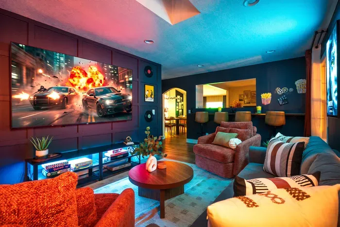 Moody media lounge with big-screen theater vibes and cozy seating