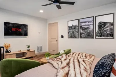 Cozy modern studio with smart TV, velvet seating, and stylish decor