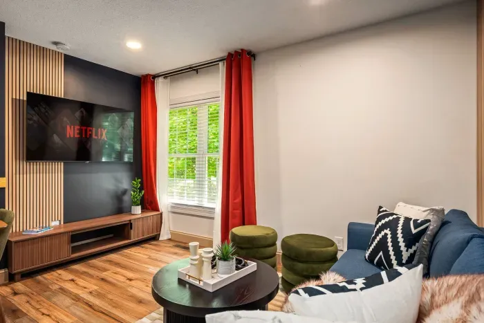 Cozy modern lounge with Netflix, bold accents, and sunny window seating
