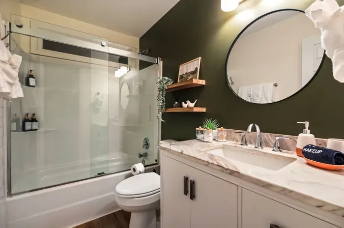 Modern bathroom with glass shower, marble vanity, and chic design touches