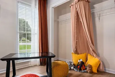 Bright bonus room with cozy kids’ nook, natural light, and workspace