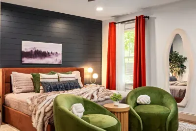 Stylish bedroom retreat with bold accents, cozy seating, and modern flair