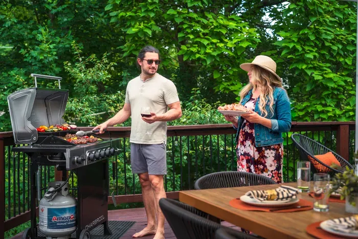 Private wooded deck with grill and outdoor dining for relaxing meals