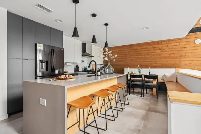 Spacious kitchen with island seating and a built-in dining nook—made extra cozy with heated floors beneath your feet.