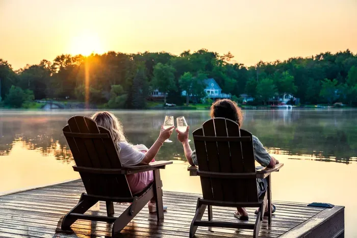 Toast to golden hour on your private dock — where calm waters, warm sunsets, and good company make every moment unforgettable!