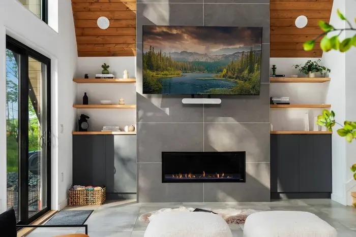 Enjoy cozy nights by the sleek gas fireplace with a movie on the big screen and Sonos surround sound filling the space. Thoughtful design and luxe textures make this the perfect place to unwind in style.