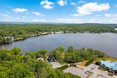Stunning aerial photo captures Moonlit Peak’s incredible lakefront location, with sweeping views of serene waters and surrounding natural beauty. Highlighted also is the close proximity of The Lodge, a hub of premium amenities and activities.