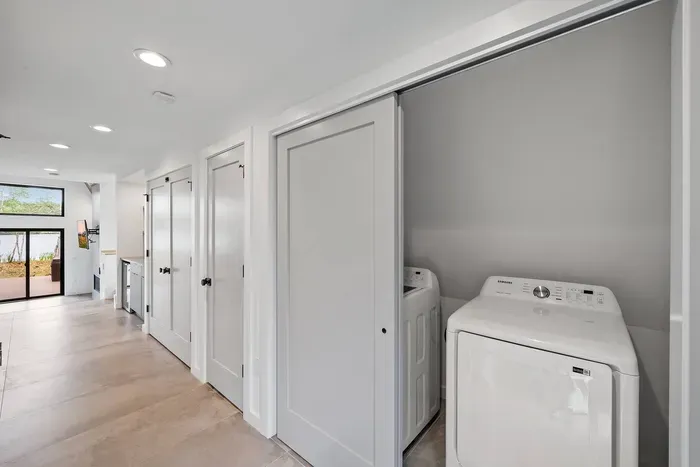 This first floor laundry area offers the ultimate convenience for guests.  Equipped with a washer and dryer tucked neatly behind sliding doors, it's perfect for extended stays or quick clean-ups after a day of exploring.