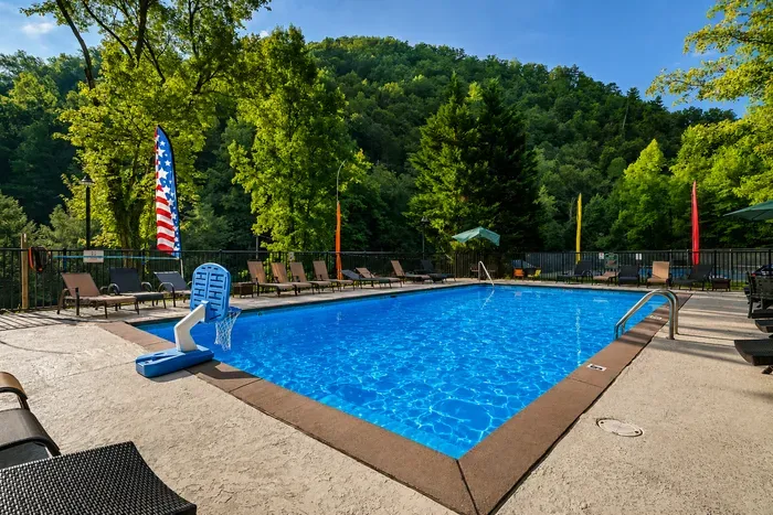 Community pool featuring a fun basketball hoop, perfect for family-friendly outdoor entertainment.