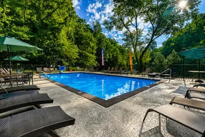 Refresh in the community outdoor pool with ample lounge chairs and relaxing wooded surroundings.