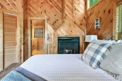 Relax and unwind in a bedroom kissed by firelight.