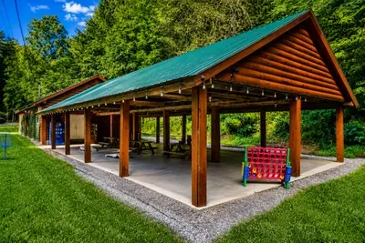 Spacious covered pavilion with picnic tables, outdoor games, and plenty of room for family gatherings.